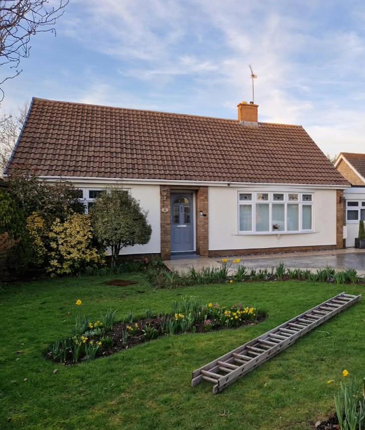 A clean tiled roof and exterior wall on a house