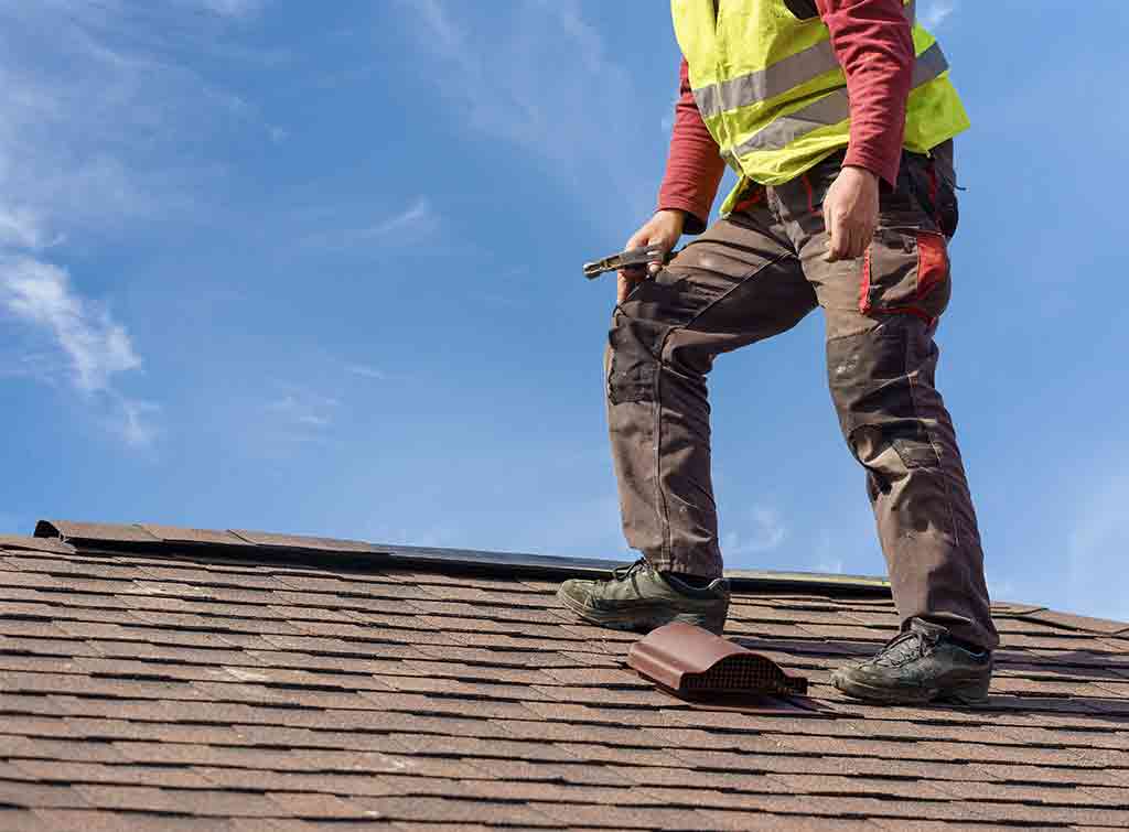 Cracked and slipped roof tiles being repaired on a pitched roof